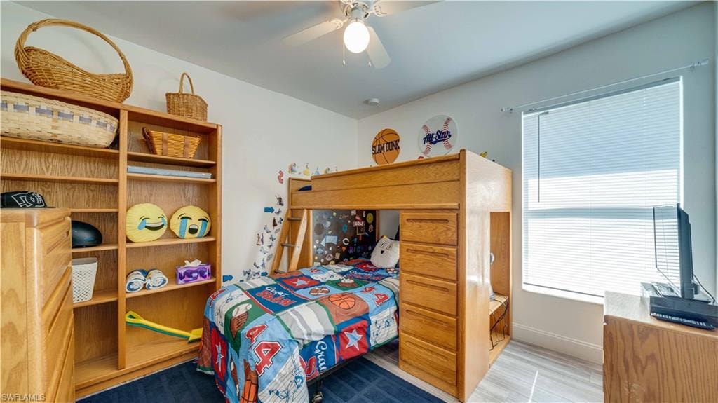 Bedroom with ceiling fan and wood finished floors