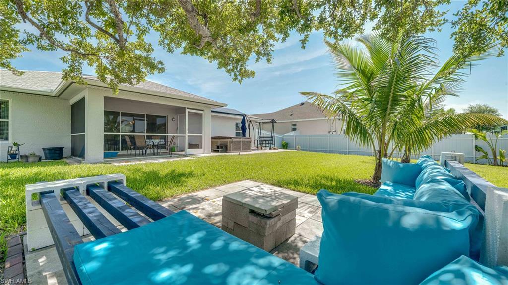Back of property with a patio, an outdoor hangout area, stucco siding, a yard, and a sunroom