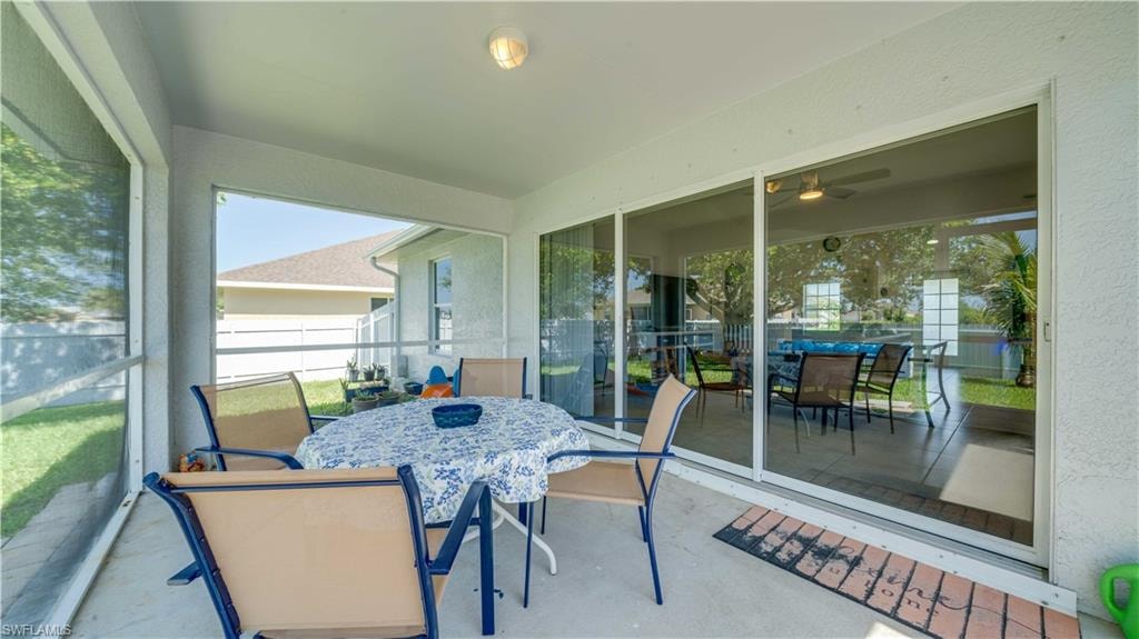 Sunroom / solarium featuring outdoor dining space and ceiling fan