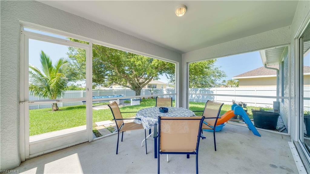 Sunroom featuring outdoor dining space and plenty of natural light