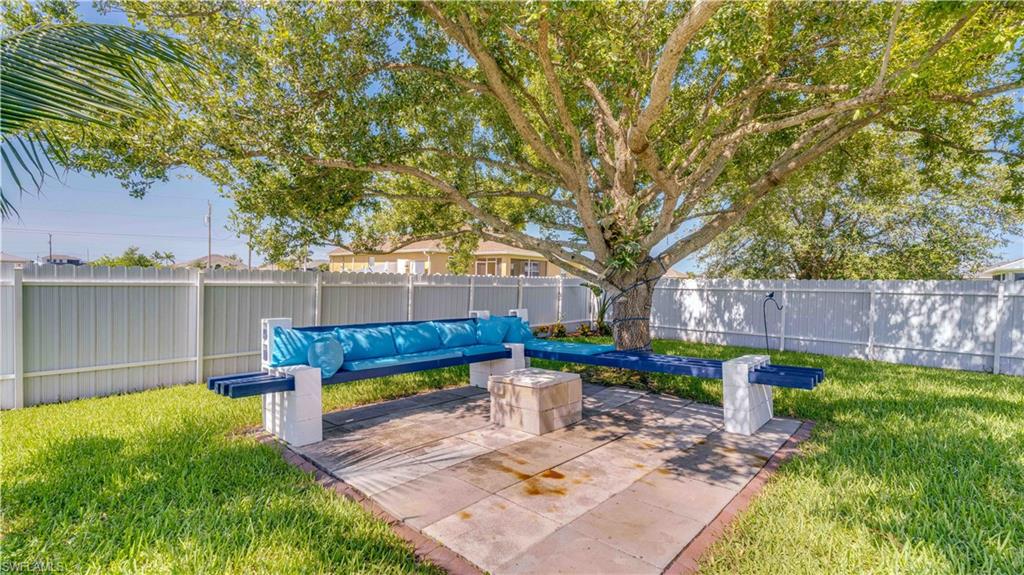 Fenced backyard with a patio and an outdoor living space