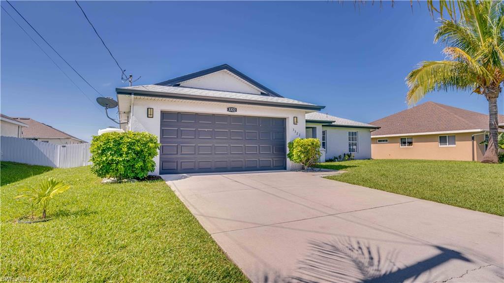 Single story home with stucco siding, concrete driveway, a garage, and a shingled roof