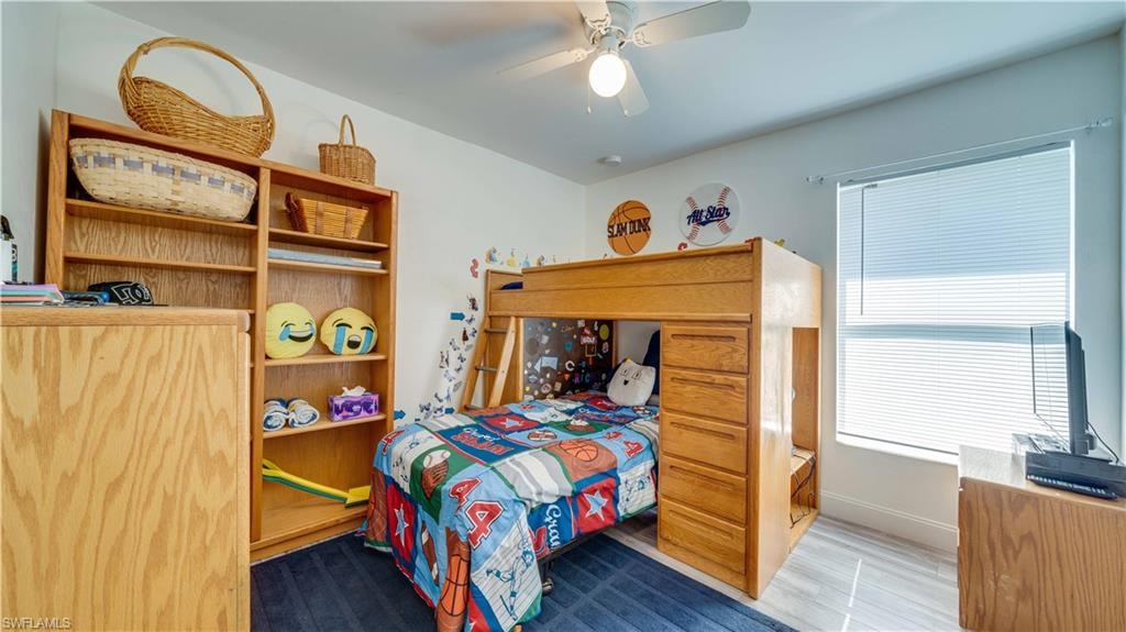 Bedroom with a ceiling fan and wood finished floors