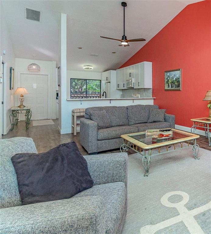 Living area with lofted ceiling and ceiling fan