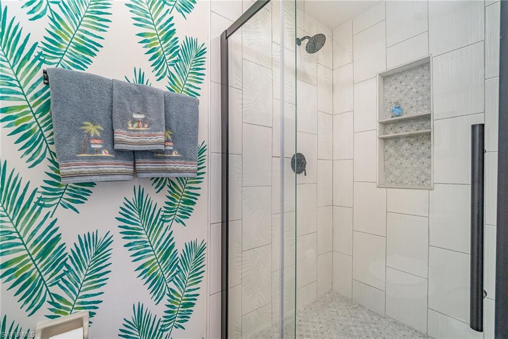 Full bathroom featuring a shower stall