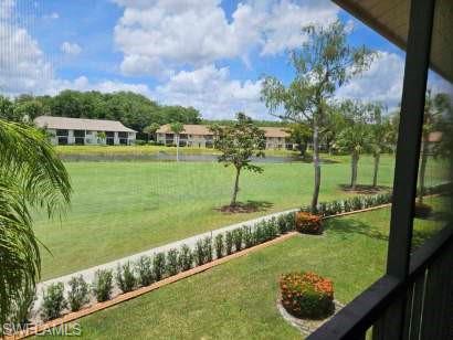 View of grassy yard with a water view