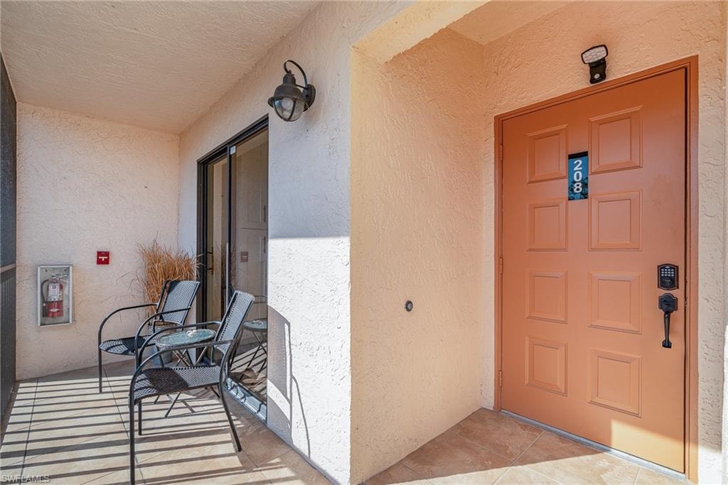 Doorway to property with stucco siding