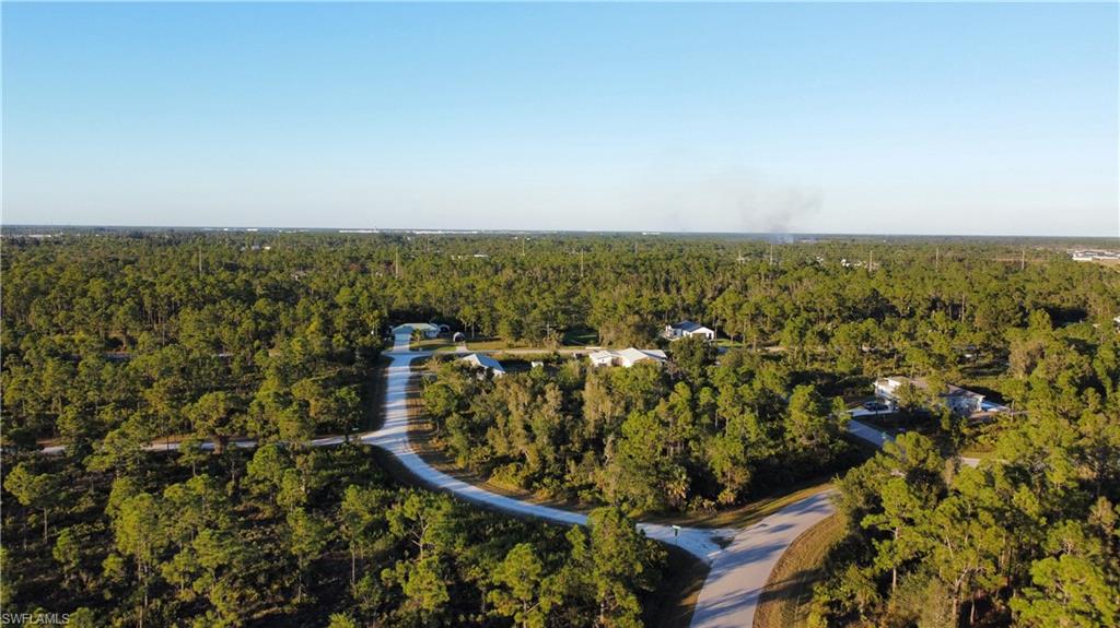 Aerial view of property's location featuring a forest