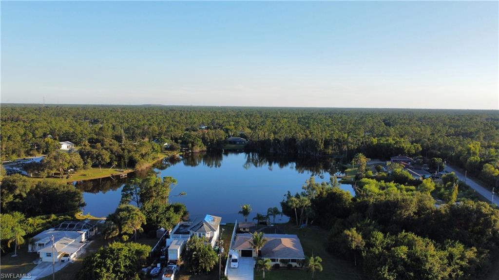 Bird's eye view of a heavily wooded area and a nearby body of water