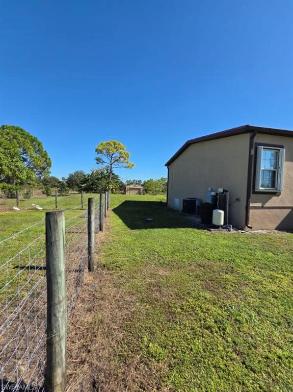 View of property exterior with stucco siding and a central air condition unit