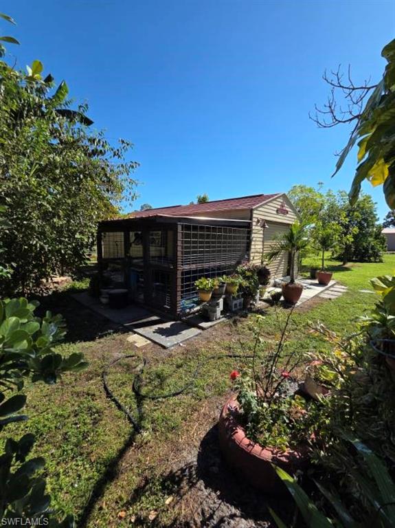 View of property exterior featuring a lawn