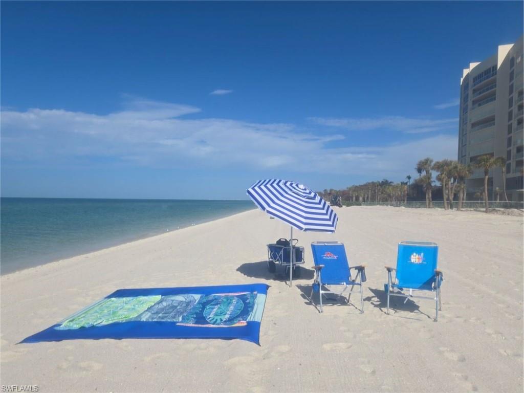 Surrounding community featuring a water view and a view of the beach