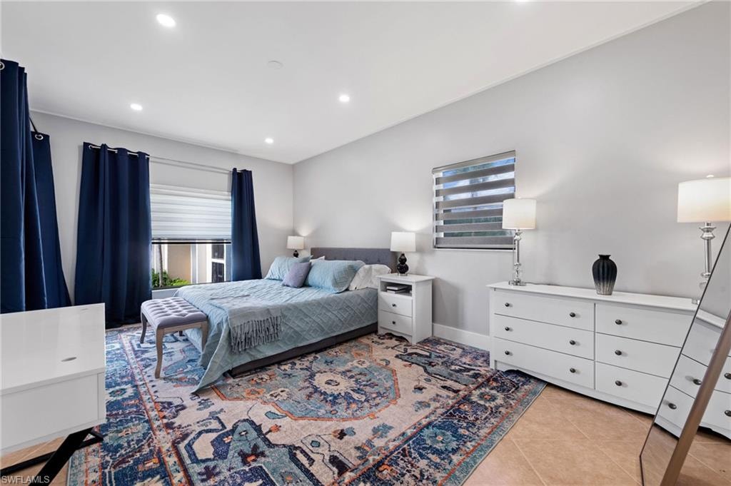 Bedroom featuring light tile patterned floors and recessed lighting