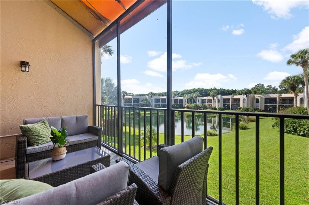 Balcony with a water view, a sunroom, and outdoor lounge area