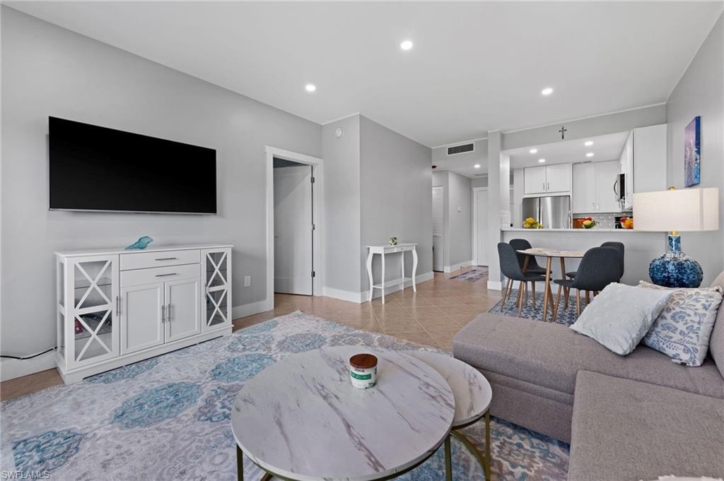 Living area with recessed lighting and light tile patterned flooring