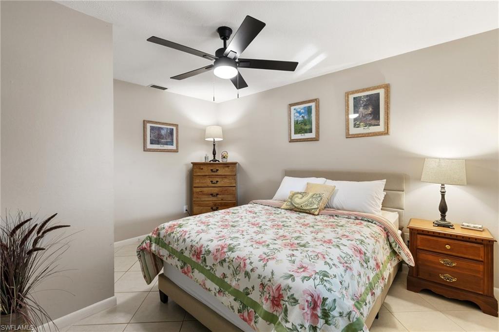 Bedroom featuring light tile patterned floors and ceiling fan