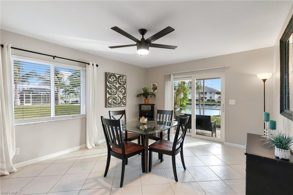 Dining area featuring light tile patterned flooring and ceiling fan