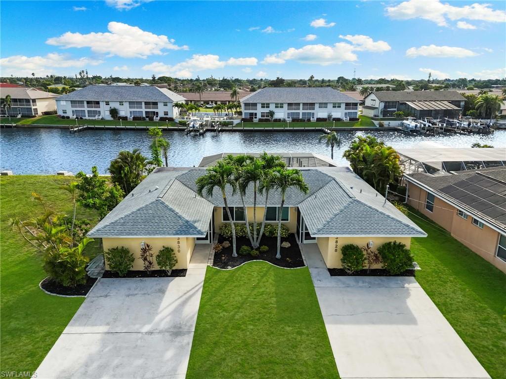 Aerial perspective of suburban area featuring a nearby body of water