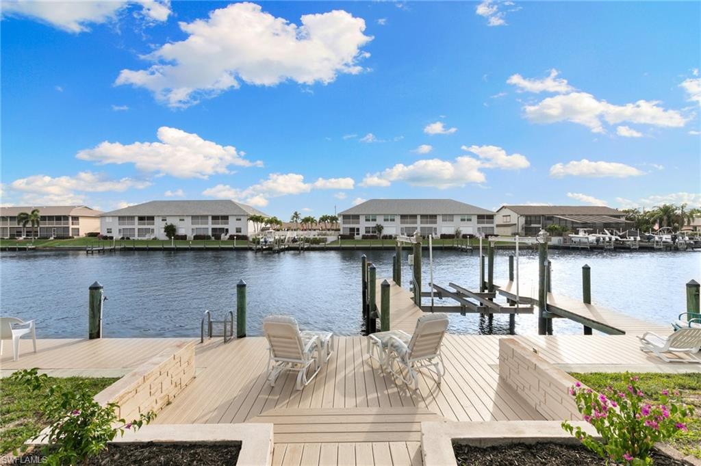 Dock area featuring a residential view, a water view, and boat lift