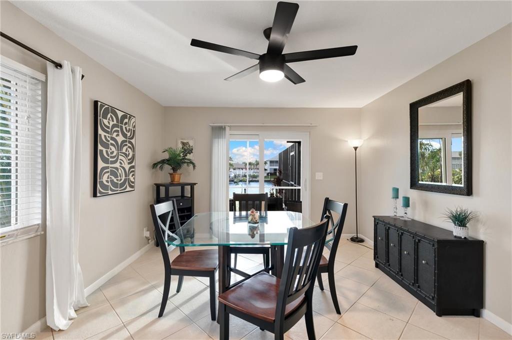 Dining space with light tile patterned flooring and ceiling fan