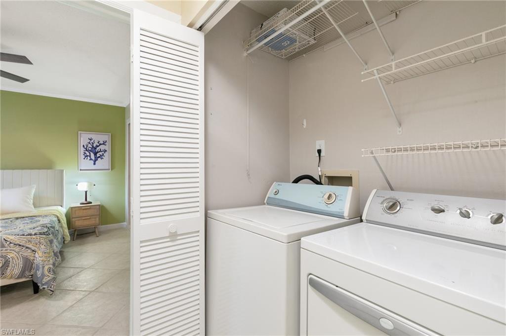 Washroom featuring light tile patterned floors and separate washer and dryer