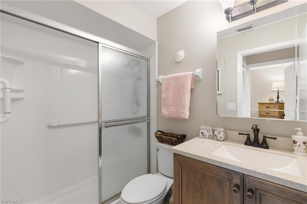 Full bath with vanity and a shower stall
