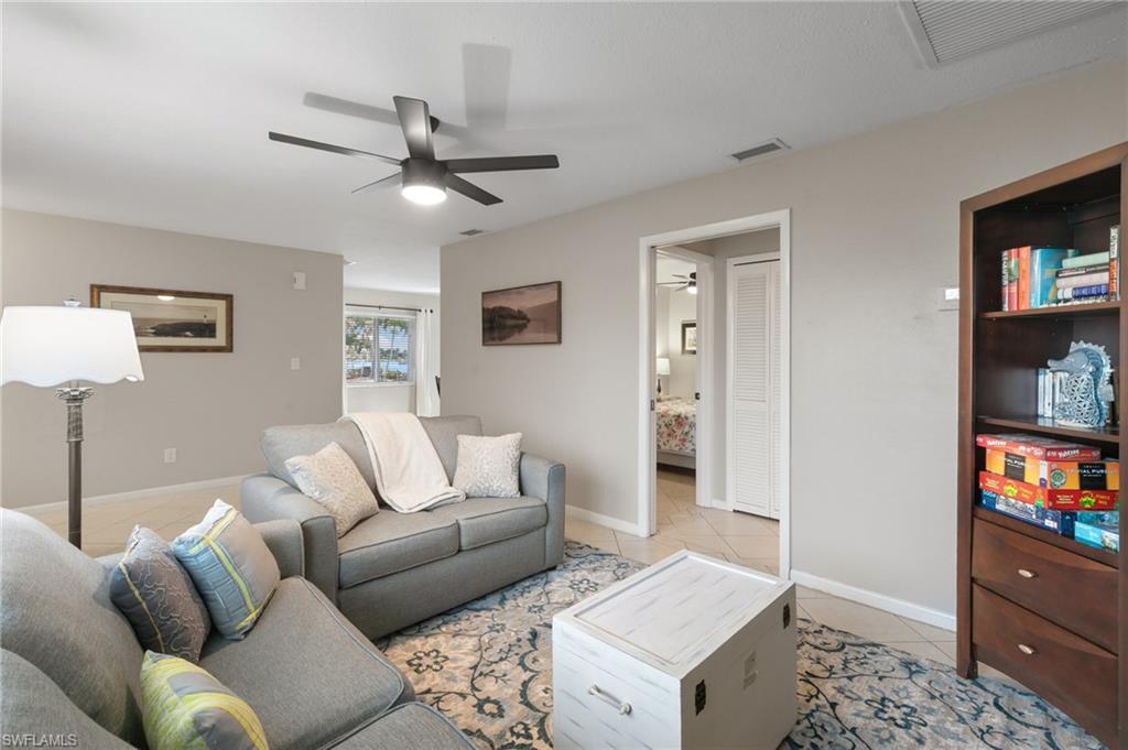 Living room featuring light tile patterned floors and baseboards