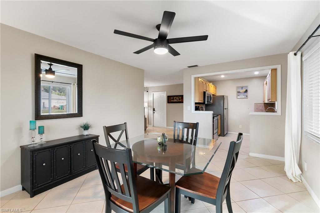 Dining area featuring light tile patterned flooring and ceiling fan