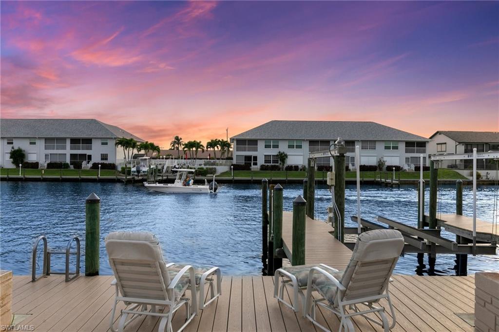 Dock with a water view and a residential view
