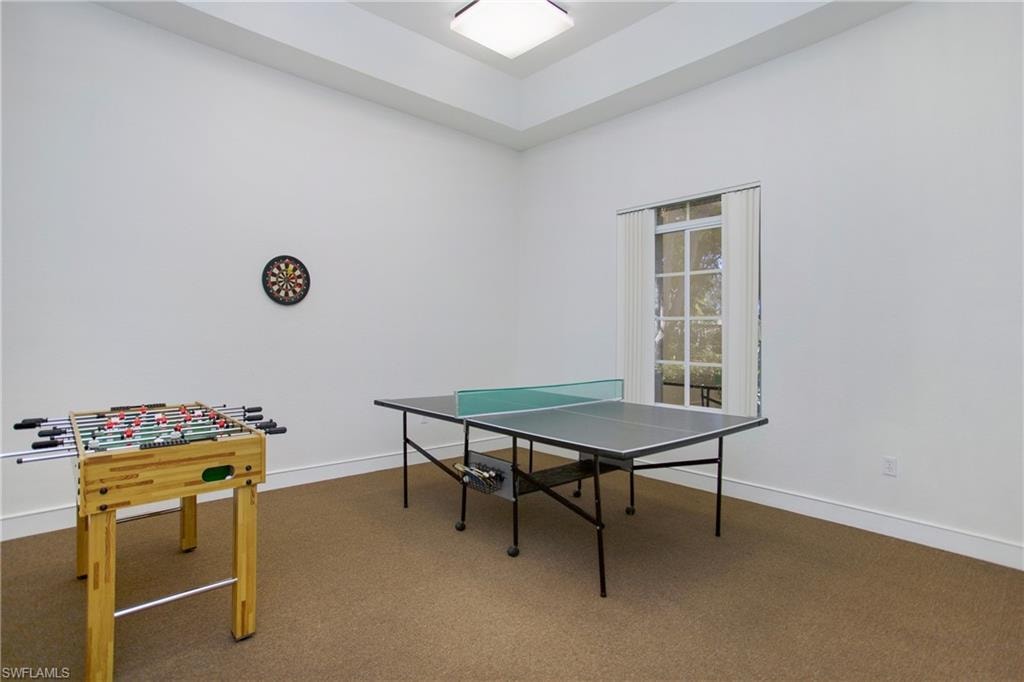 Playroom with carpet and a raised ceiling