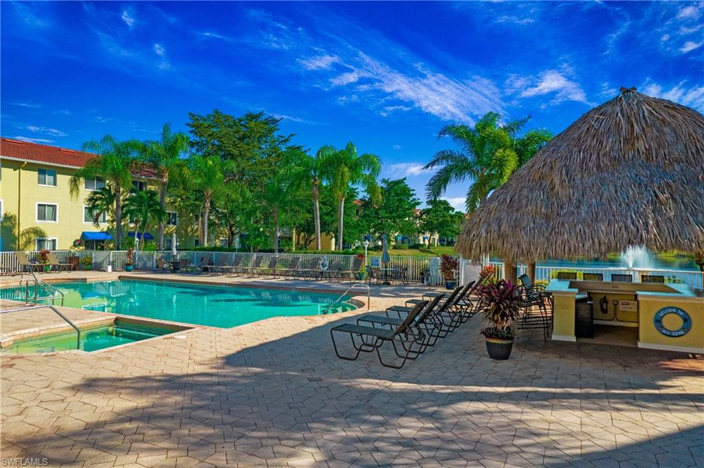 Community pool with a patio area and a community hot tub