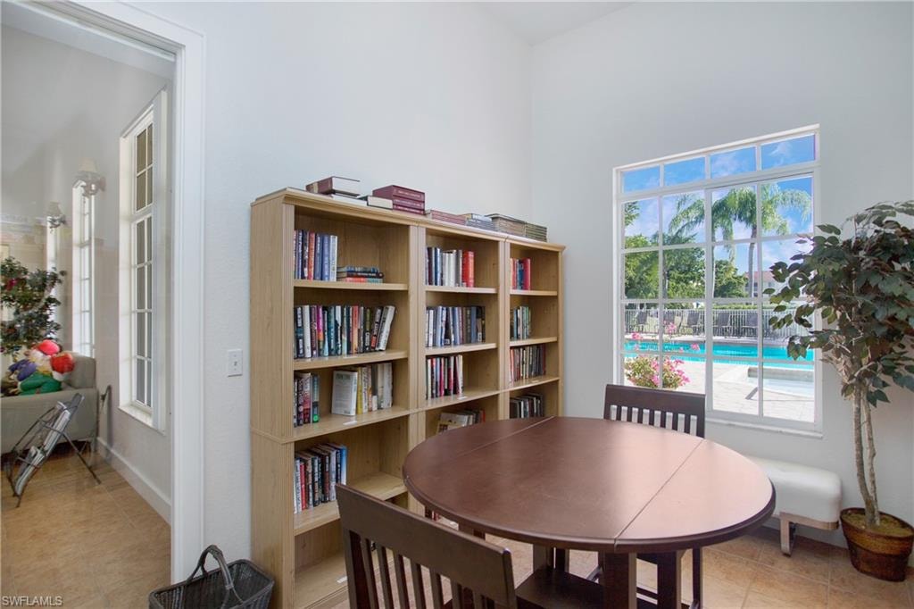 Living area with light tile patterned floors and baseboards