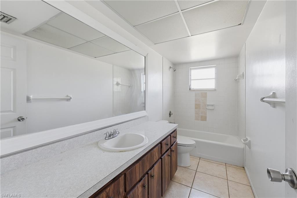 Bathroom with  shower combination, vanity, and light tile patterned flooring