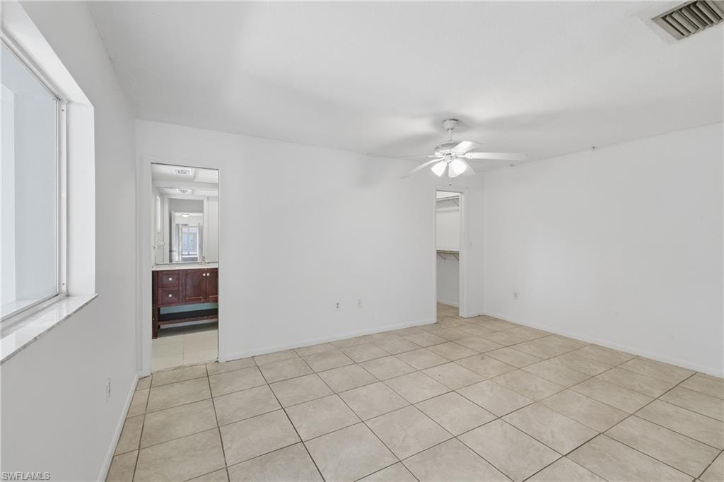 Spare room featuring ceiling fan and light tile patterned flooring