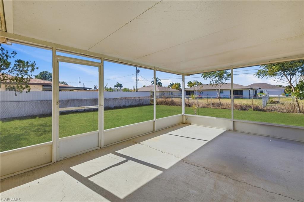 Unfurnished sunroom with plenty of natural light and a residential view