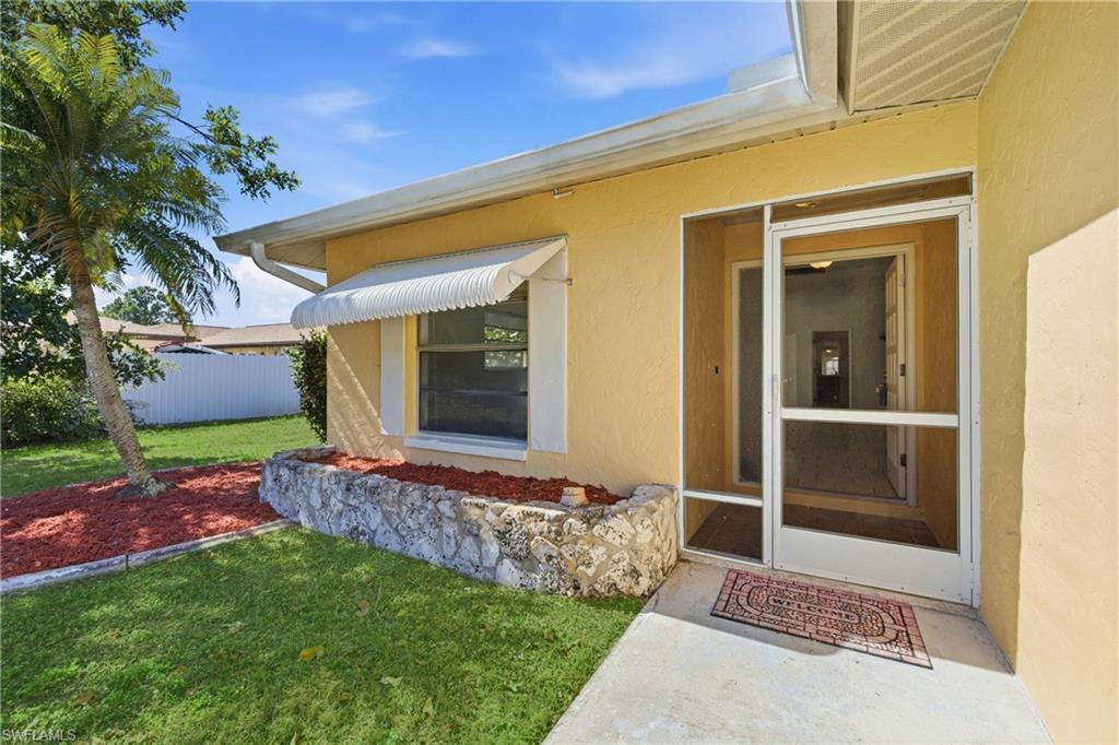 Entrance to property featuring stucco siding