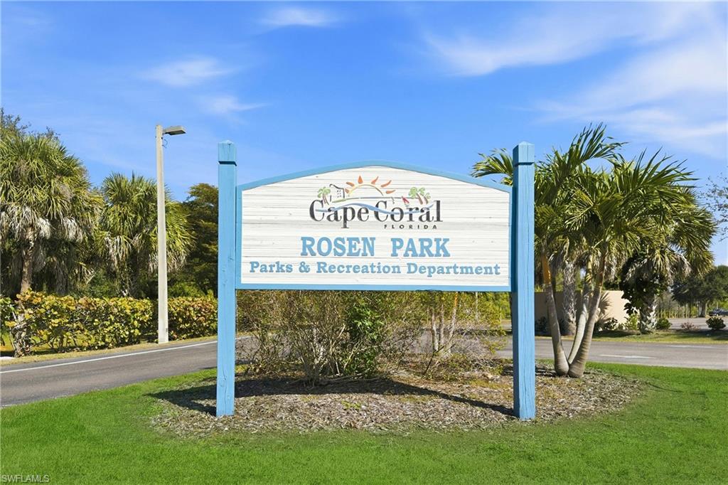 Community sign featuring a lawn