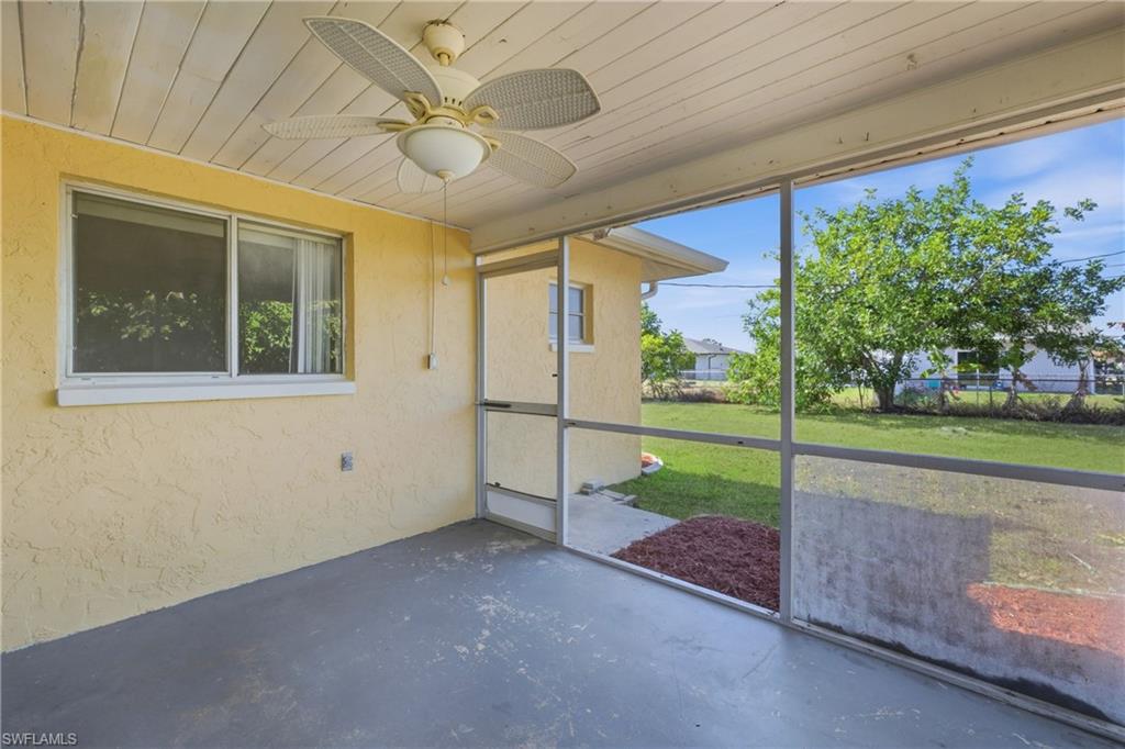 Unfurnished sunroom featuring ceiling fan