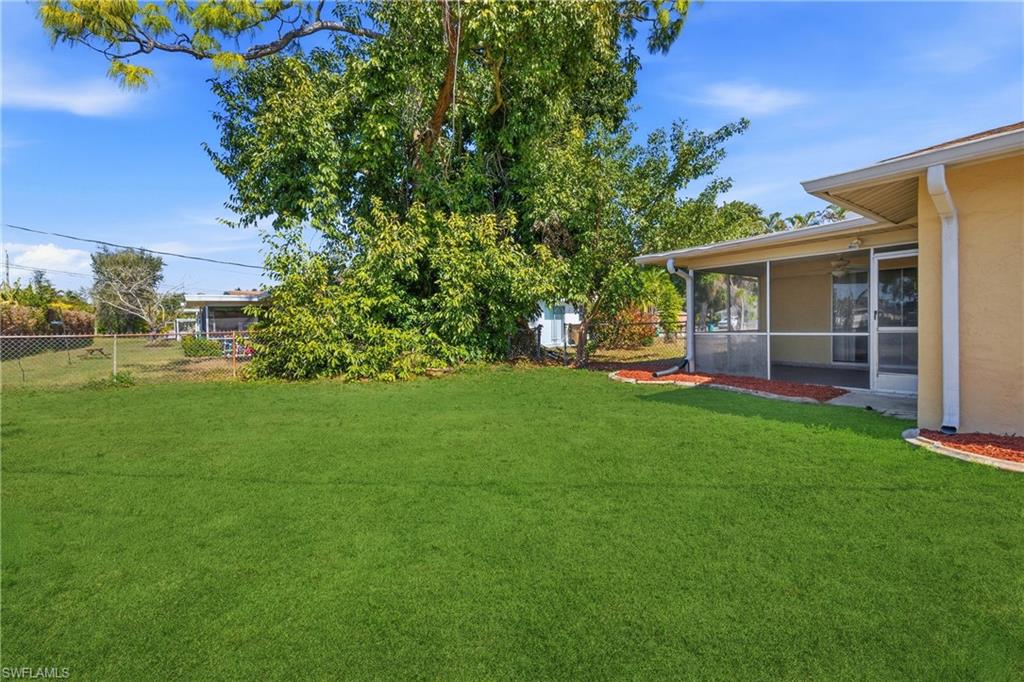 View of yard featuring a sunroom