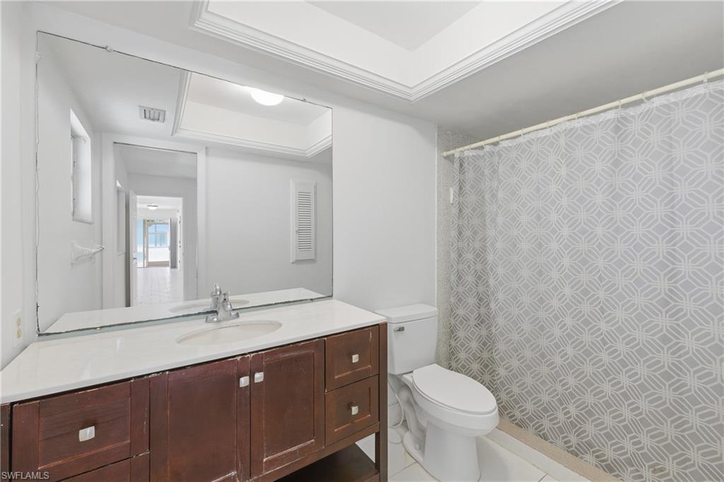 Full bath with vanity, a shower with curtain, and tile patterned flooring