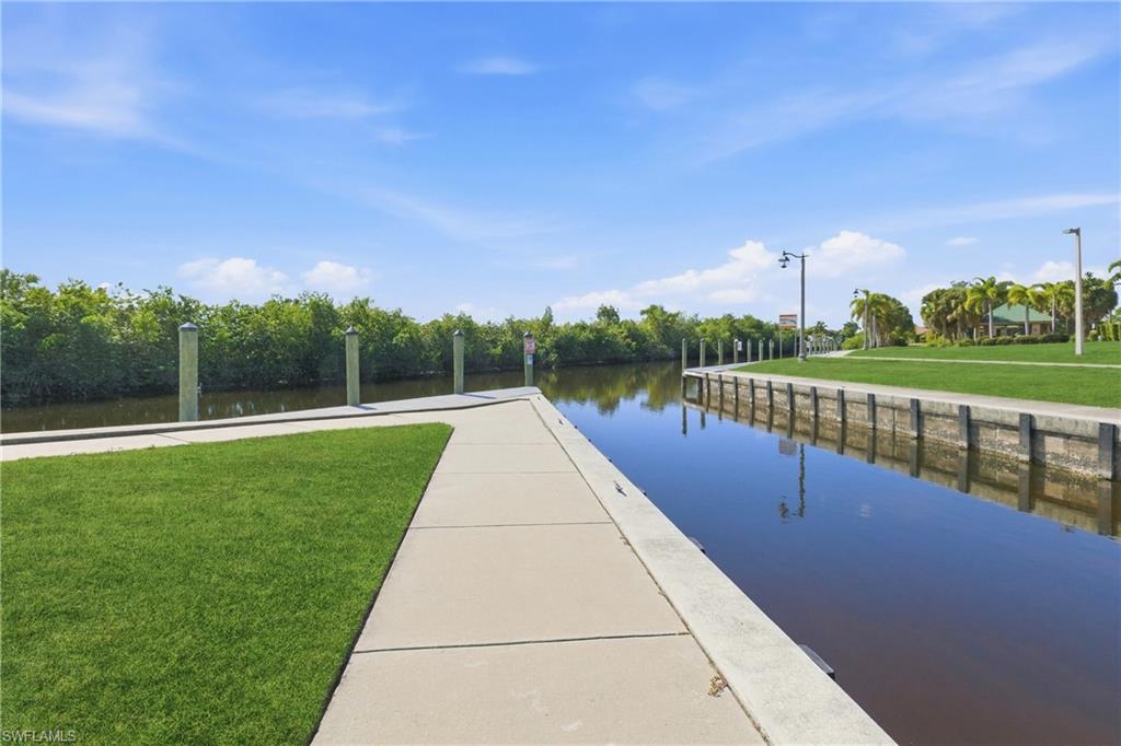 Dock with a lawn and a water view