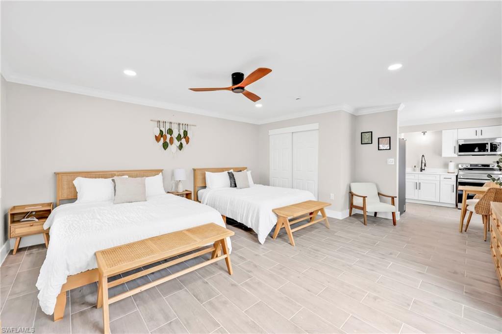 Bedroom featuring ornamental molding, recessed lighting, a closet, a ceiling fan, and light wood-style flooring