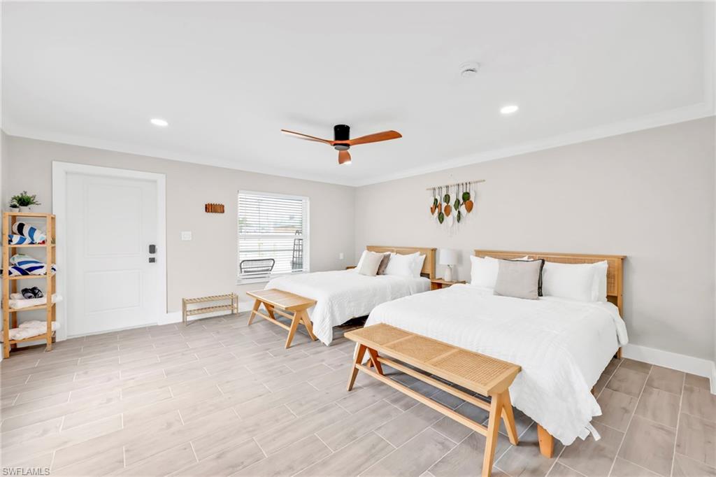 Bedroom featuring recessed lighting, ceiling fan, wood finish floors, and crown molding
