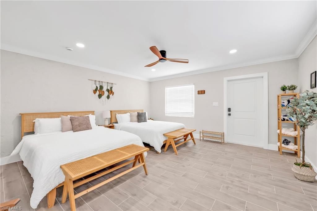 Bedroom with ornamental molding, a ceiling fan, recessed lighting, and wood finish floors