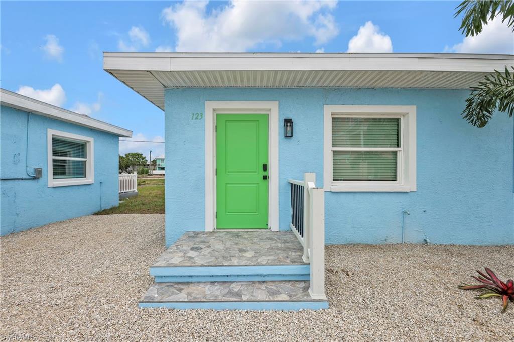 View of exterior entry with stucco siding