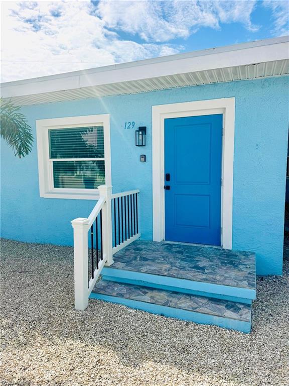 Property entrance featuring stucco siding