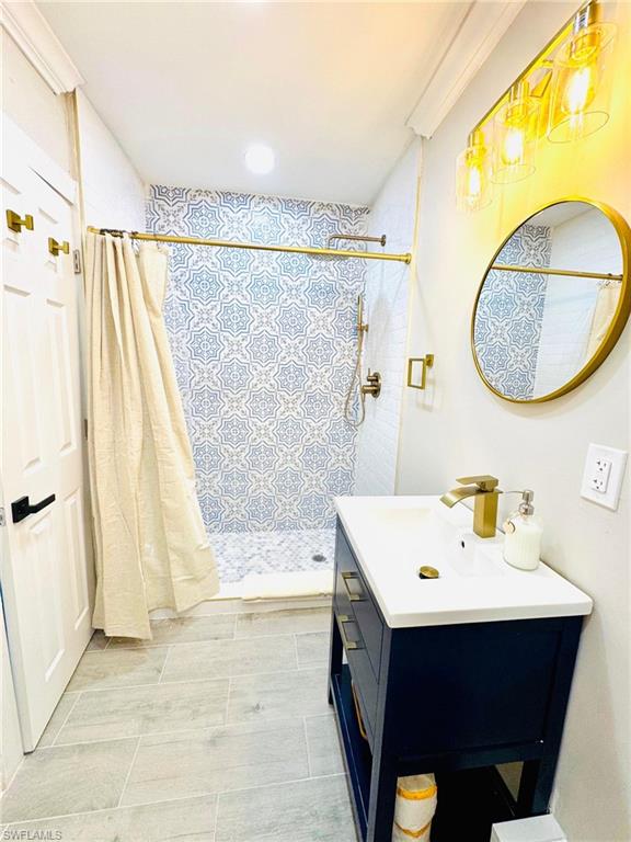 Full bath with a shower stall, vanity, and recessed lighting