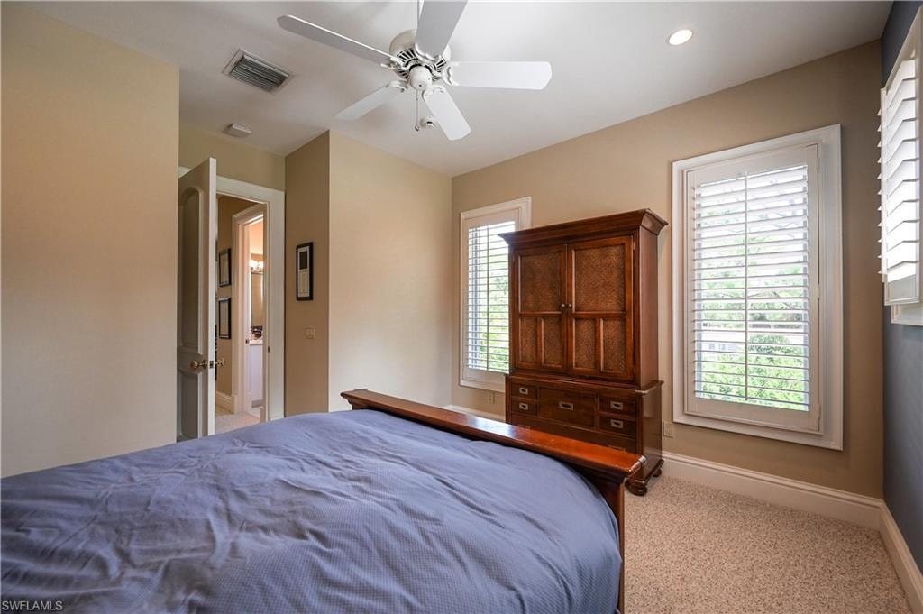 Guest apartment Bedroom with light carpet and a ceiling fan