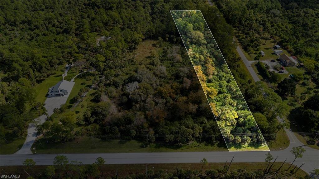 Aerial overview of property's location featuring a heavily wooded area and property boundaries highlighted