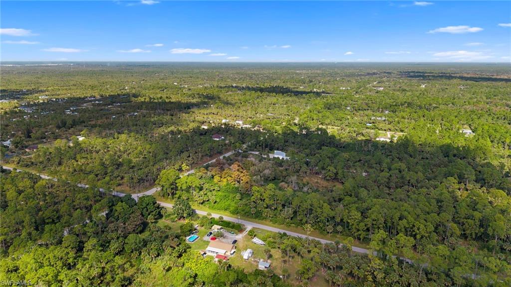 View of property location featuring a forest